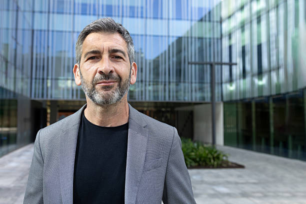 istock Confident businessman smiling in front of modern office building 2230761851