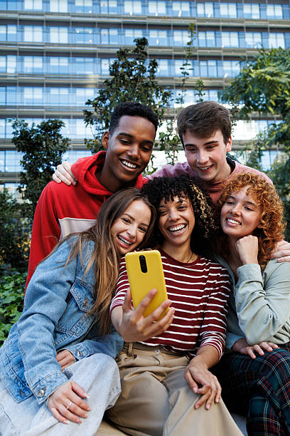 istock Group of students taking a selfie in front of university building 2230761857
