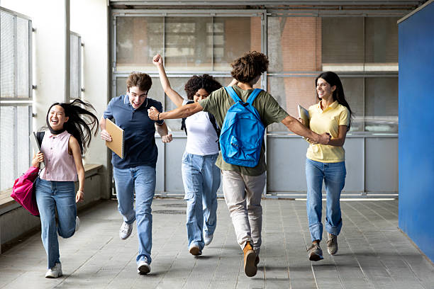 istock Happy students running in university hallway after class 2230761859
