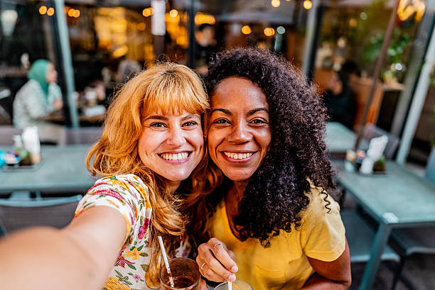 istock Friends taking a selfie at sidewalk cafe - Camera point of view 2230773367