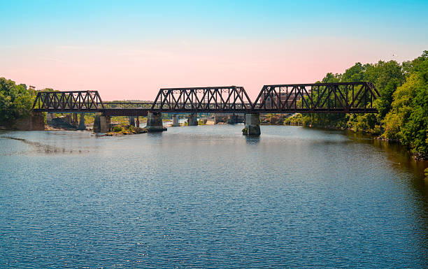 istock Rustic railway tracks and the historic WatervilleWinslow Railroad Bridge span the Kennebec River in Waterville, Maine, USA 2230775688