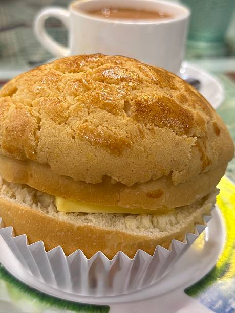 Close-up of iconic Hong Kong pineapple bread aka (港式菠萝包) and cup of milk tea on the table