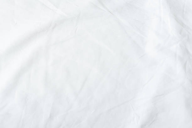istock White bedsheet background, bed sheet texture, wrinkled duvet, crumpled satin blanket comforter cloth used in hotel, resort or home interior for bedding sleep comfort 2230780510