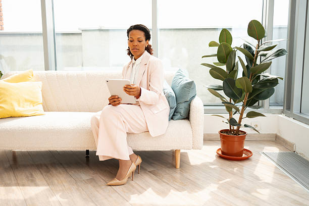 istock Businesswoman using a tablet while seated in a modern and elegant workspace 2230780787