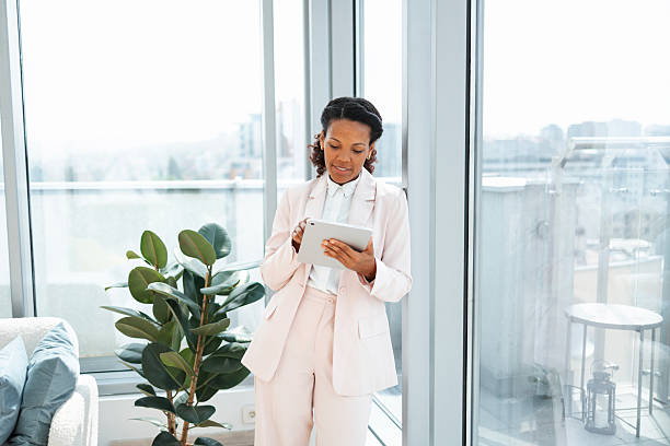 istock Confident professional woman working on a tablet in a modern office space 2230780805