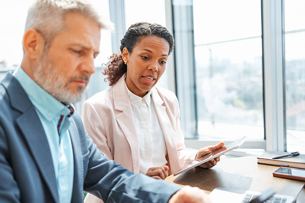 istock Two business professionals discussing a report in a modern office 2230780931