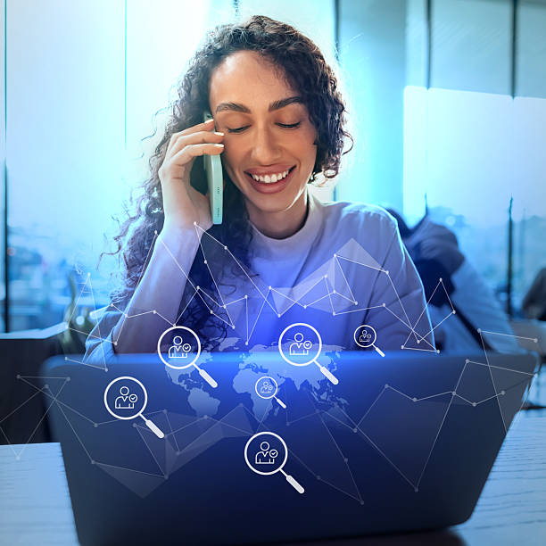 istock Business professional engaged in remote work while smiling on phone with digital connections in the background 2230781671