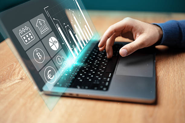 istock Analyzing financial data on a laptop with graphs and currency symbols displayed 2230781738