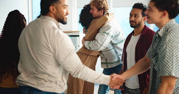istock Students, handshake and congratulations in classroom, college and happy for education goals. People, men and women with hug, shaking hands or support for success, achievement or results at university 2230782823