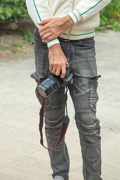 istock Photographer holding a digital camera taking pictures in nature. 2230783632