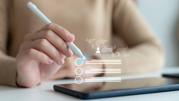 istock Hand using a stylus on a tablet with a virtual checklist and profile form. Concept of digital form filling, online application, user interface, and smart technology. 2230787074