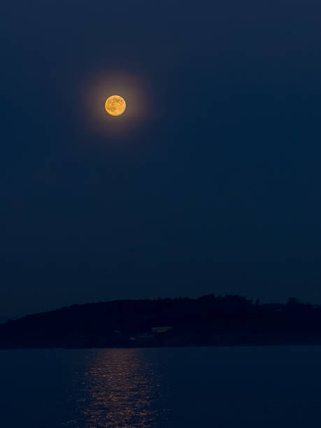 istock Full Moon Over Calm Sea at Night 2230789674