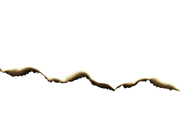 Burnt torn paper edge with wavy scorched border, isolated on white background with clipping path.