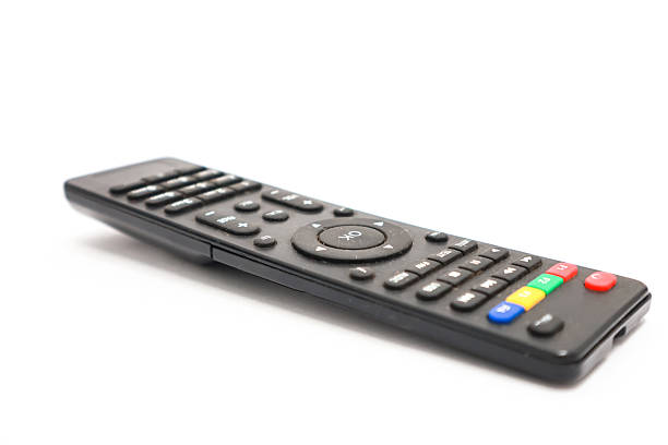 istock Close-up of a sleek black universal remote control on a pristine white surface 2230791982