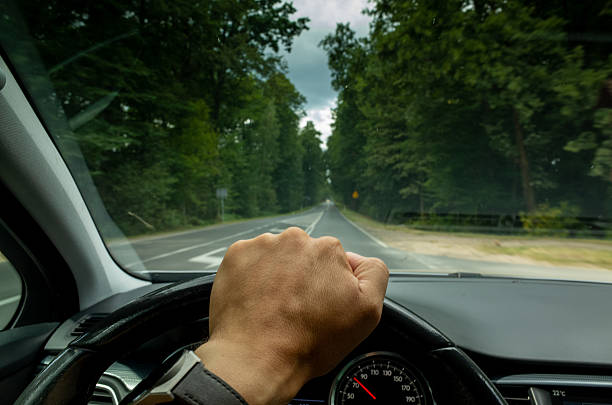 istock Man is driving a car and his hand is on the steering wheel 2230792685