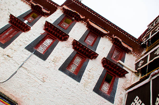 Golden-roofed temples of Kumbum Monastery glow under the sun, where intricate Tibetan carvings meet swirling incense in this sacred Qinghai sanctuary.