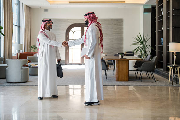istock Confident Arabic Hotel Manager Welcomes Businessman with Warm Handshake 2230794536