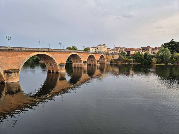 istock Bridge over river in Bergerac - stone arch reflected in water 2230796078