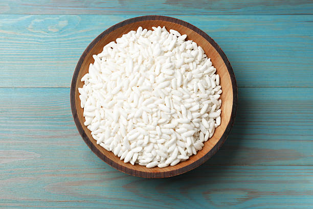 istock Puffed rice in bowl on light blue wooden table, top view 2230797635