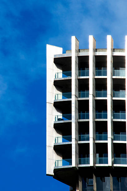 istock Modern high-rise architecture with geometric design and glass balconies, captured against a vivid blue sky, symbolizing urban living and contemporary style. 2230798879