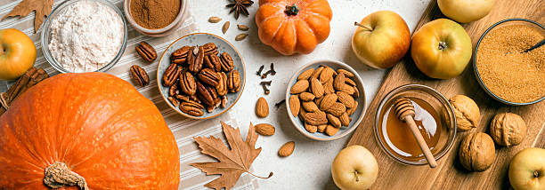istock Autumn fall baking background with pumpkins, apples, nuts, food ingredients 2230801023
