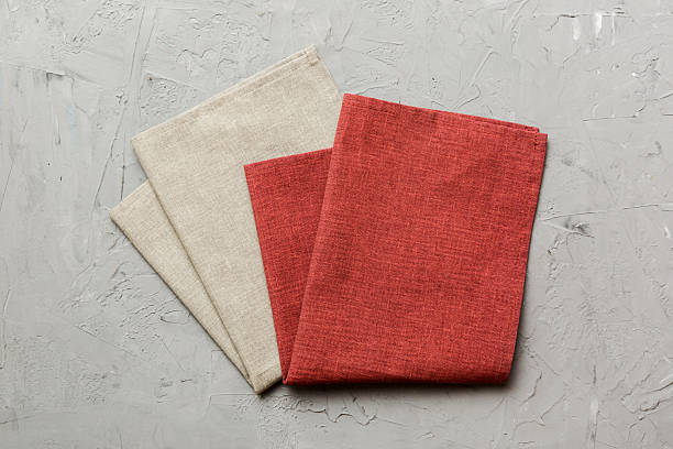 istock top view with red empty kitchen napkin isolated on table background. Folded cloth for mockup with copy space, Flat lay. Minimal style 2230801512