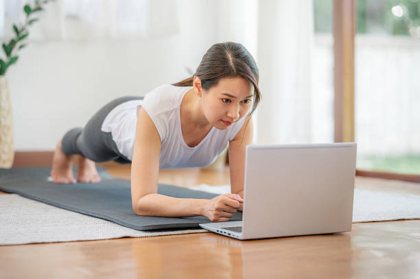 istock Asian woman doing plank exercise at home with laptop 2230802357