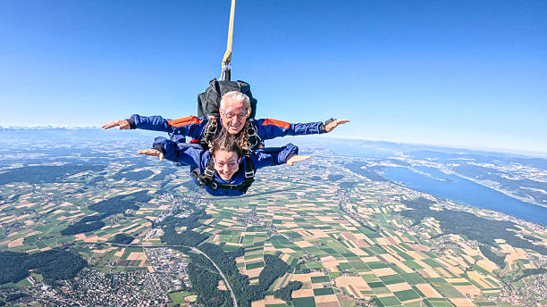 Tandem skydivers fly through air together, instructor and student, Swiss Alps