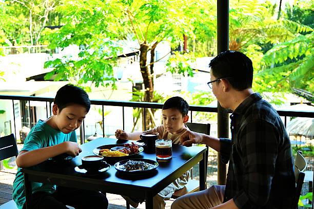 istock Family celebrating fathers day at lunch 2230804855