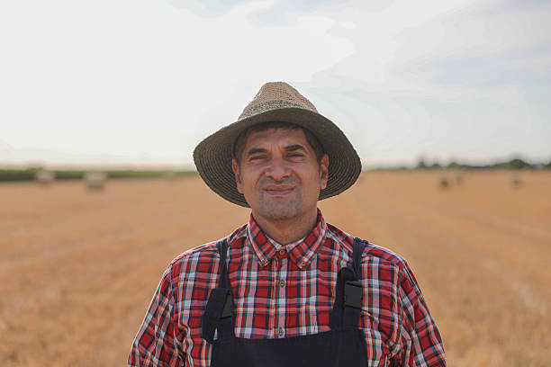 istock Proud Farmer Standing in Wheat Field with Hands on Hips 2230805220