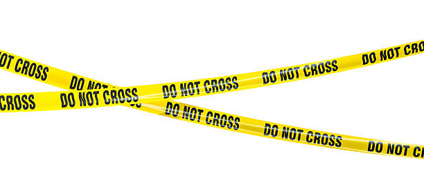 istock Two yellow do not cross tapes crossing each other on white background 2230807621