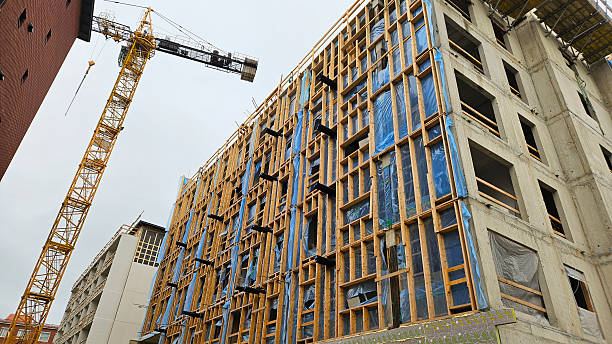 istock Wooden Building Frame at Construction Site with Crane 2230807749