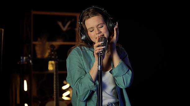 istock Young Woman Performing Energetically with Microphone on Stage 2230808730