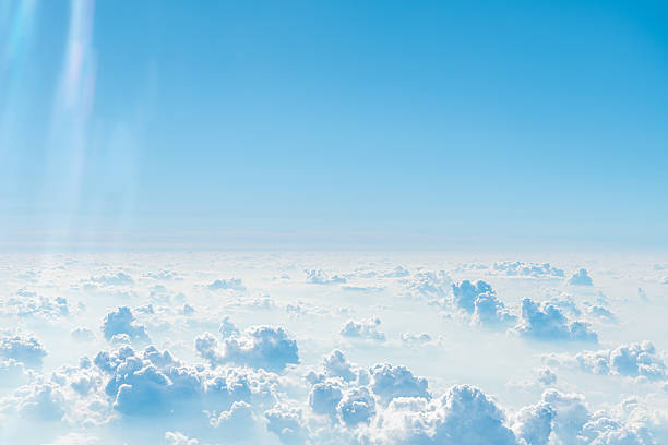 istock White fluffy clouds are floating against a vibrant blue sky, creating a picturesque cloudscape as seen from an airplane window, offering a breathtaking aerial perspective 2230808967