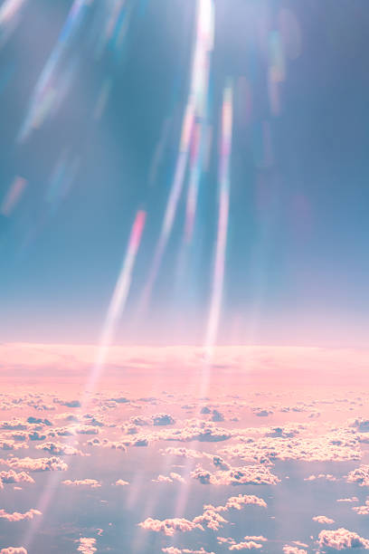 istock Sunlight streaming through fluffy clouds above creates a stunning interplay of pink and blue hues in the sky, evoking a dreamy, serene atmosphere filled with beauty and tranquility 2230809179