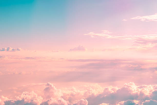 istock Soft pastel hues painting the sky, with fluffy clouds drifting gently, creating a dreamy and romantic ambiance during a breathtaking sunset filled with vibrant colors 2230809295