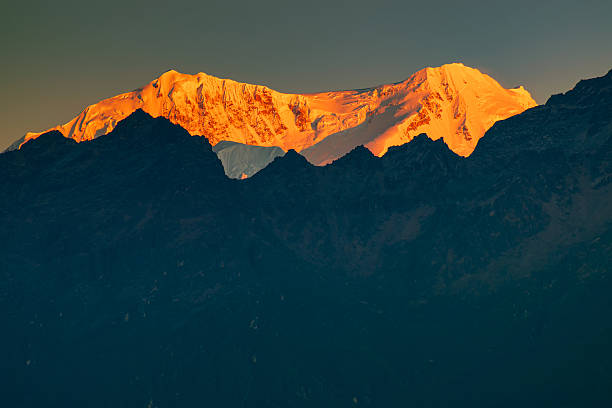 istock Beautiful first light from sunrise on Mount Kabru, part of ridge that extends south from third highest mountain in the world Kangchenjunga, Himalayan mountain range, Sikkim, India. Nepal India border. 2230809611