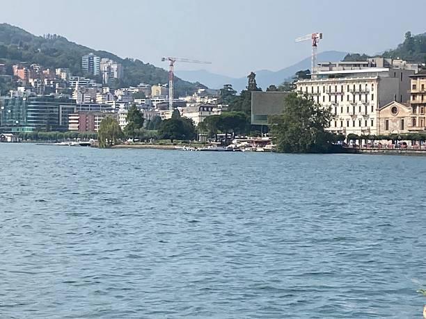istock Panoramic view of Lake Lugano with architecture in background. 2230810066