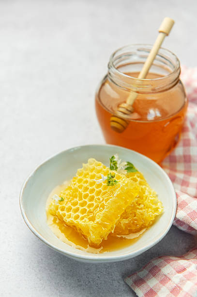 istock Honey, honeycomb and bee pollen creating delicious golden composition 2230810512
