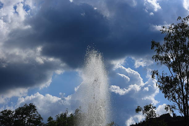 Water jet from a fountain against a cloudy sky