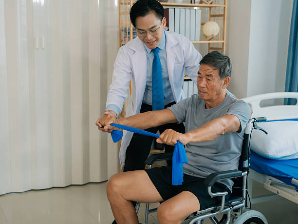 istock A skilled male physical therapist examines an elderly male patient lying on a bed, checking his muscle strength in a hospital examination room. 2230811122