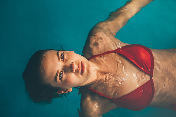 Relaxed Young Woman Enjoying Indoor Swimming Pool