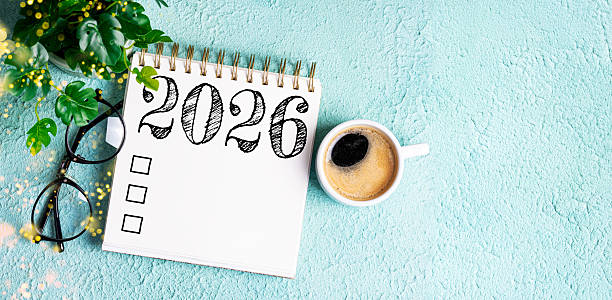 istock New year resolutions 2026 on desk. 2026 resolutions list with notebook, coffee cup on table. Goals, resolutions, plan, action, checklist concept. New Year 2026 template 2230815300