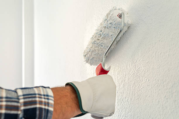 istock House painter worker painting a wall white. Building. 2230820677