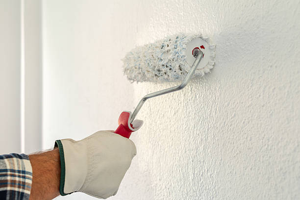 istock House painter worker painting a wall white. Building. 2230820682