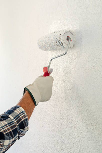 istock House painter worker painting a wall white. Building. 2230820723