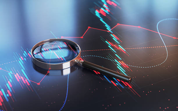 istock Magnifying Glass on Blue Red Financial Chart Background 2230823684