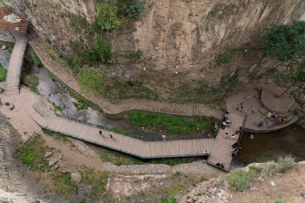 istock Wooden Walkway Inside Historical Canyon with People 2230823737