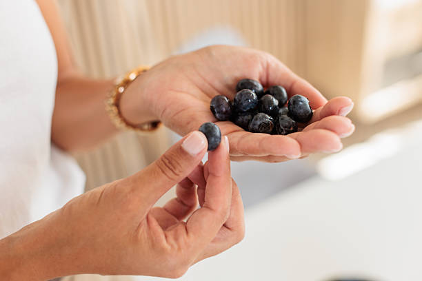 istock Close-Up of Hands Holding Fresh Blueberries 2230823899
