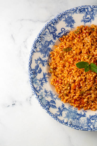 istock Traditional turkish bulgur pilaf with tomato sause in plate (Turkish name; meyhane pilavi) 2230824304